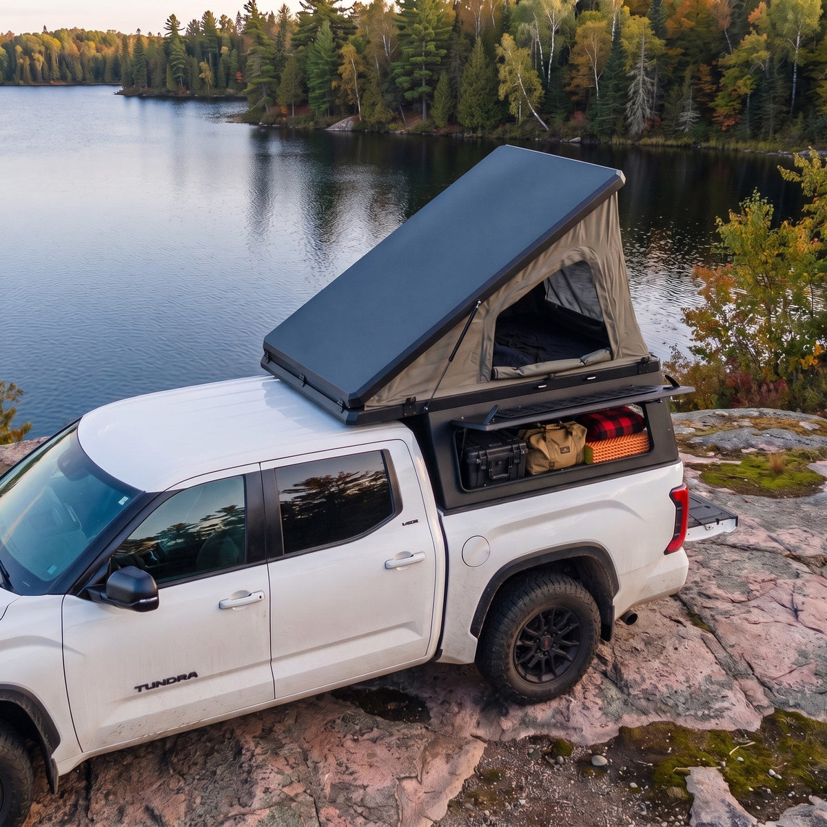 Truck cap camper with a pop-up rooftop tent on a Toyota Tundra beside a northern Ontario lake — TruckTon Truck Accessories