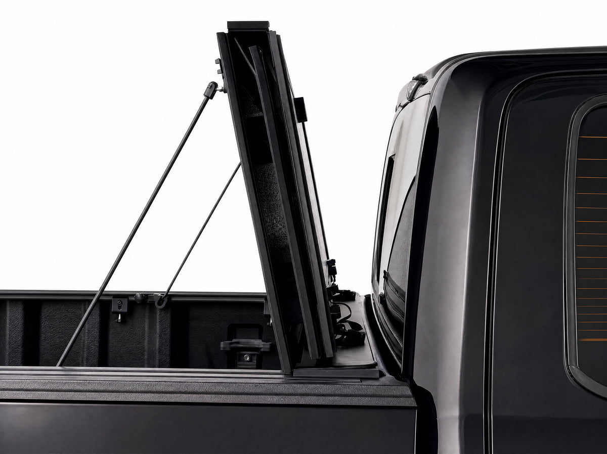 Cover folded fully upright against the cab, secured with prop rods