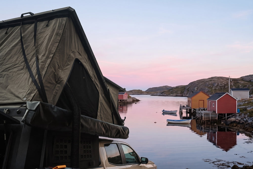 Side of the open roof tent on a Chevy Colorado, overlooking a Newfoundland fishing cove at dawn (the side awning shown is not included)