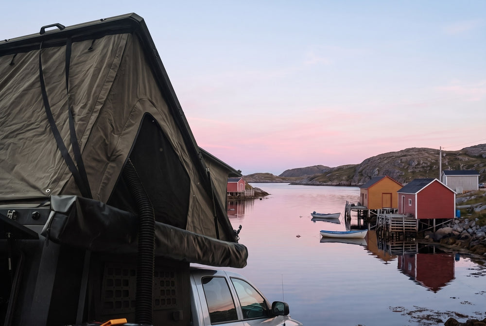 Side of the open roof tent on a Dodge Ram 2500/3500, overlooking a Newfoundland fishing cove at dawn (the side awning shown is not included)