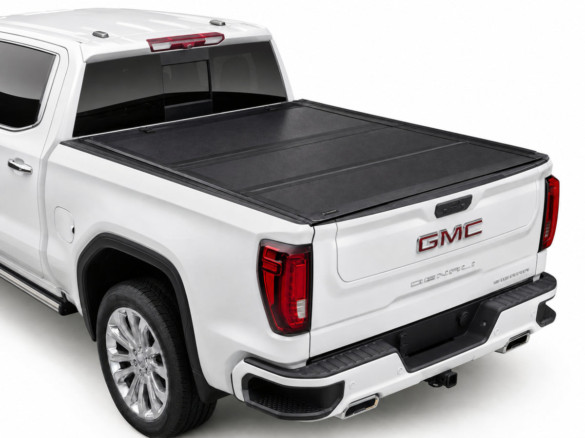 TruckTon hard flip-back tonneau cover closed — low-profile matte black panels