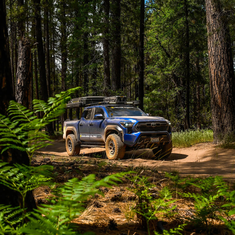 Toyota Tacoma with M'LinkX roof rack on a forest trail