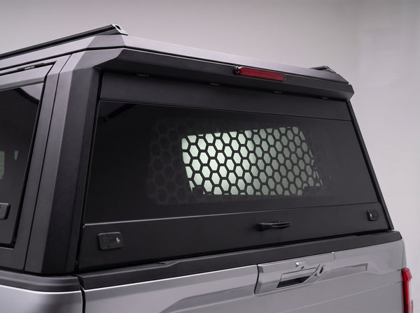 Honeycomb security guard behind the tinted glass of the Chevrolet Colorado truck cap