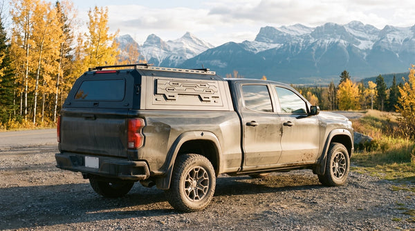 Truck cap vs canopy in practice: an aluminum canopy on a pickup at an Alberta trailhead in fall