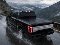 Sealed flip-back tonneau cover in heavy rain on a mountain highway — view 18