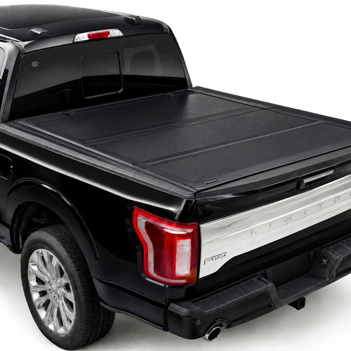 TruckTon hard flip-back tonneau cover closed — low-profile matte black aluminum panels