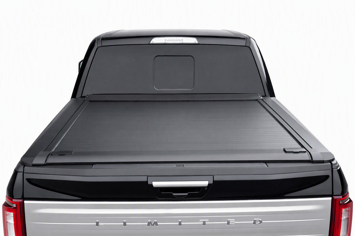 Retractable cover fully retracted into its canister — open truck bed
