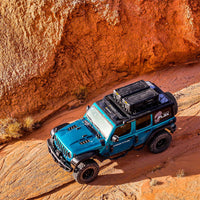 Jeep with FLEX cargo cases driving a desert canyon, aerial view — view 8