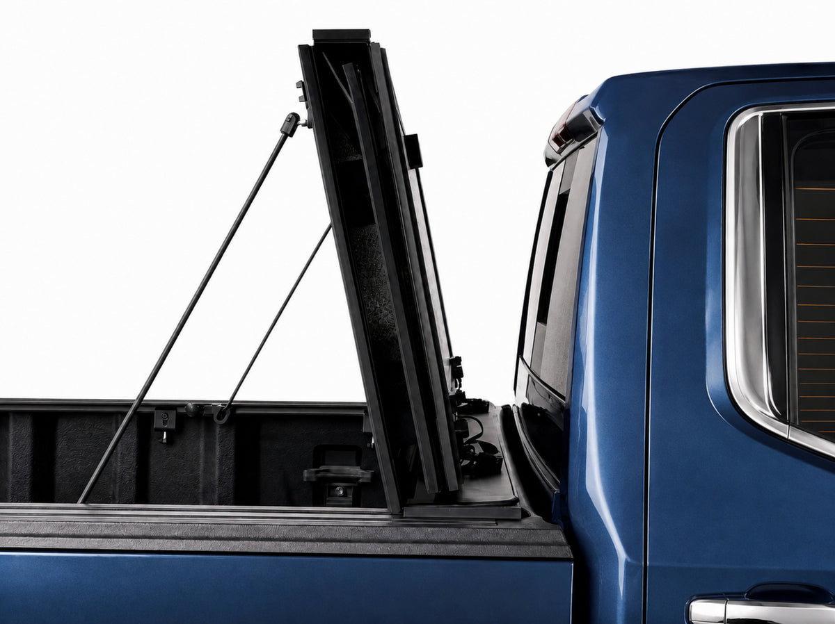 Cover folded fully upright against the cab, secured with prop rods