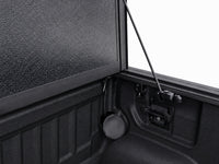 Latch mechanism, drain tube and prop rod detail inside the bed — view 17