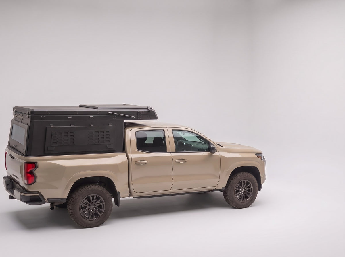 Step 1, closed for driving: the Double Pop-Up truck cap camper packed flat on a Chevy Colorado