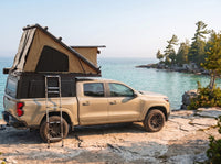 Chevy Colorado Double Pop-Up truck cap camper with the roof tent open on the Georgian Bay shoreline in Ontario