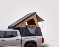 Studio side view of the Single Pop-Up truck cap camper on a Chevrolet Colorado