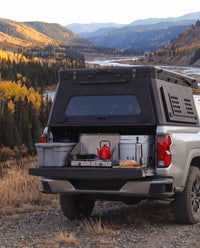 Tailgate camp kitchen under the rear hatch of a Chevrolet Colorado truck bed camper