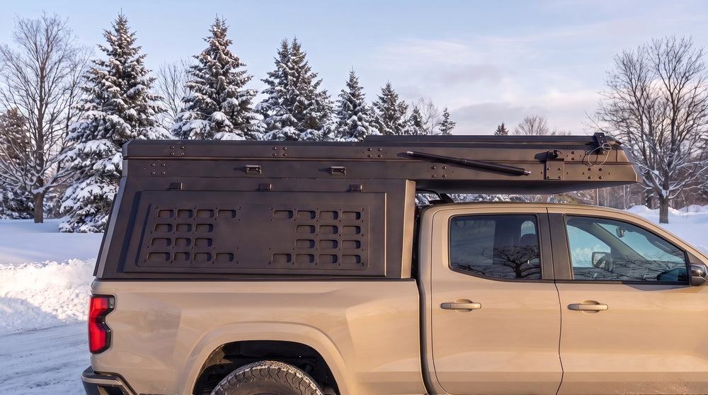 Chevy Colorado truck cap camper closed up for winter driving on a snowy Ontario road