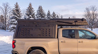 Chevy Colorado truck cap camper closed up for winter driving on a snowy Ontario road