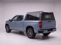 Chevy Silverado 1500 truck cap with the honeycomb security guard showing through the tinted rear window, studio view
