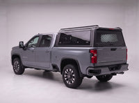 Chevy Silverado 2500HD 3500HD truck cap with the honeycomb security guard showing through the tinted rear window, studio view