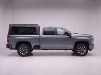 Side profile of a Chevy Silverado 2500HD 3500HD fitted with the TruckTon aluminum truck cap with tinted windows
