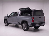 Lift-up side window open on the Chevy Silverado 2500HD 3500HD truck cap, giving access to tool cases in the bed from beside the truck