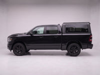 Side profile of a Dodge Ram 1500 fitted with the TruckTon aluminum truck cap with tinted windows