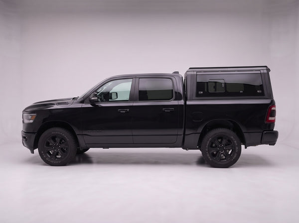 Side profile of the truck cap on a Dodge Ram 1500, following the cab lines