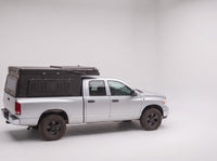 Step 1, closed for driving: the Double Pop-Up truck cap camper packed flat on a Dodge Ram 2500/3500