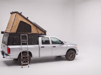 Step 2, main roof up: the roof tent open with the second hatch still closed, on a Dodge Ram 2500/3500