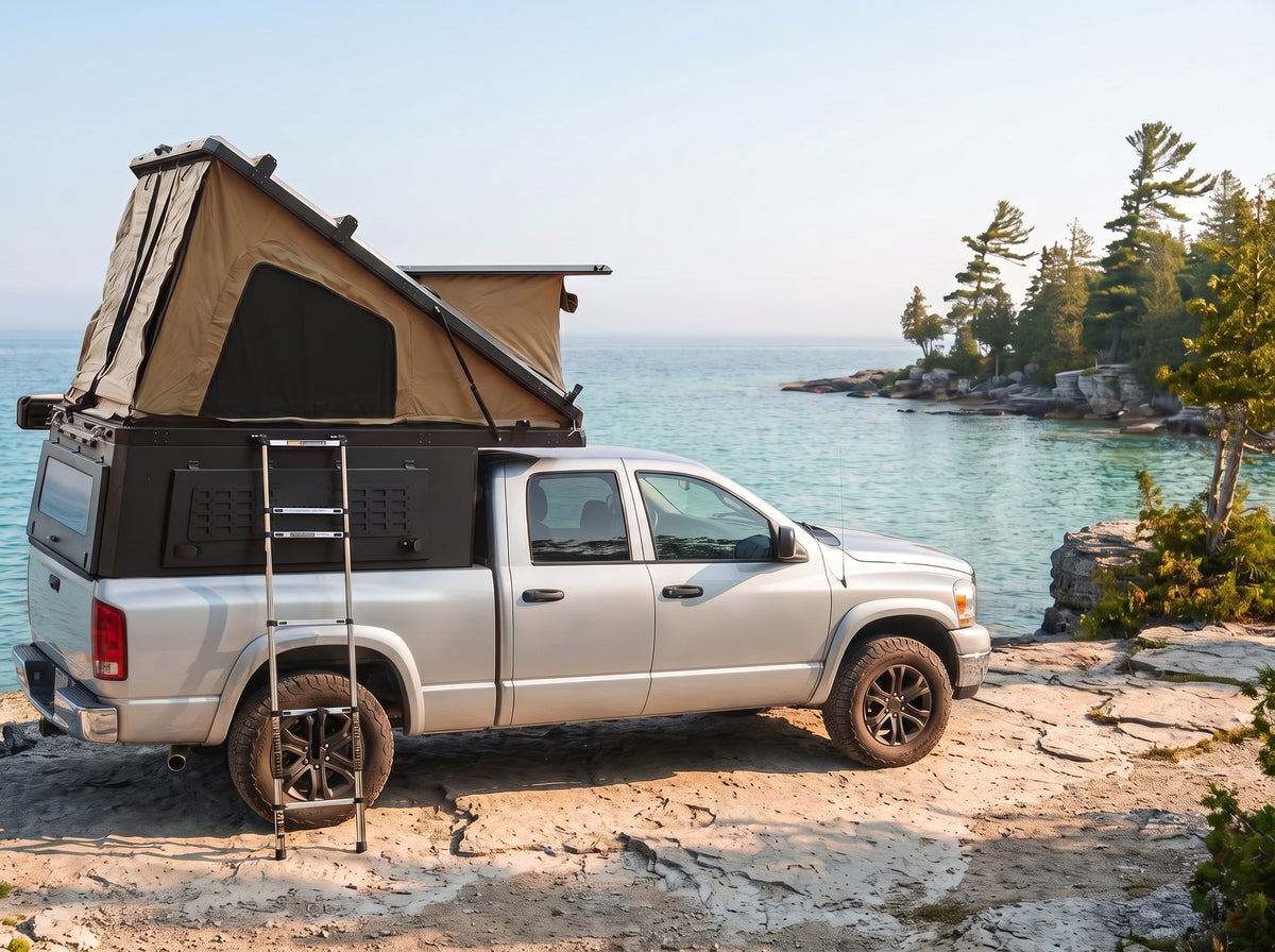 Dodge Ram 2500/3500 Double Pop-Up truck cap camper with the roof tent open on the Georgian Bay shoreline in Ontario