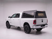 Dodge Ram 2500 3500 truck cap with the honeycomb security guard showing through the tinted rear window, studio view