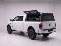 Lift-up side window open on the Dodge Ram 2500 3500 truck cap, giving access to tool cases in the bed from beside the truck
