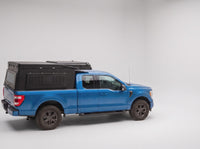 Step 1, closed for driving: the Double Pop-Up truck cap camper packed flat on a Ford F-150