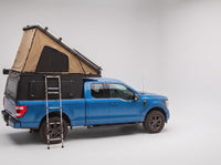 Step 2, main roof up: the roof tent open with the second hatch still closed, on a Ford F-150