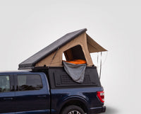 Studio side view of the Single Pop-Up truck cap camper on a Ford F-150