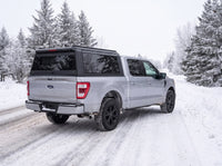 Ford F-150 with an aluminum truck cap on a snow-covered Ontario road in winter