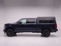 Side profile of a Ford F-250 F-350 Super Duty fitted with the TruckTon aluminum truck cap with tinted windows