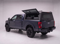 Lift-up side window open on the Ford F-250 F-350 Super Duty truck cap, giving access to tool cases in the bed from beside the truck