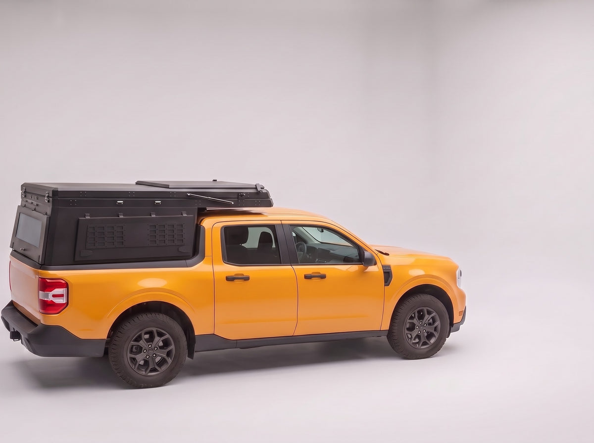 Step 1, closed for driving: the Double Pop-Up truck cap camper packed flat on a Ford Maverick
