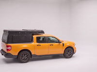Step 1, closed for driving: the Double Pop-Up truck cap camper packed flat on a Ford Maverick