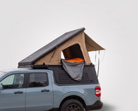 Studio side view of the Single Pop-Up truck cap camper on a Ford Maverick