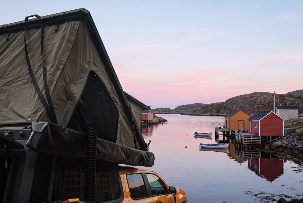 Side of the open roof tent on a Ford Maverick, overlooking a Newfoundland fishing cove at dawn (the side awning shown is not included)