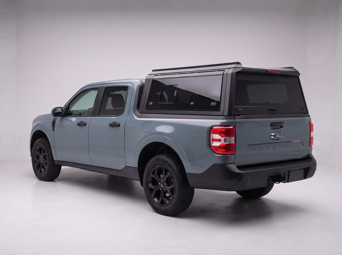 Matte black aluminum truck cap with tinted windows on a Ford Maverick, studio rear three-quarter view