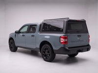 Matte black aluminum truck cap with tinted windows on a Ford Maverick, studio rear three-quarter view
