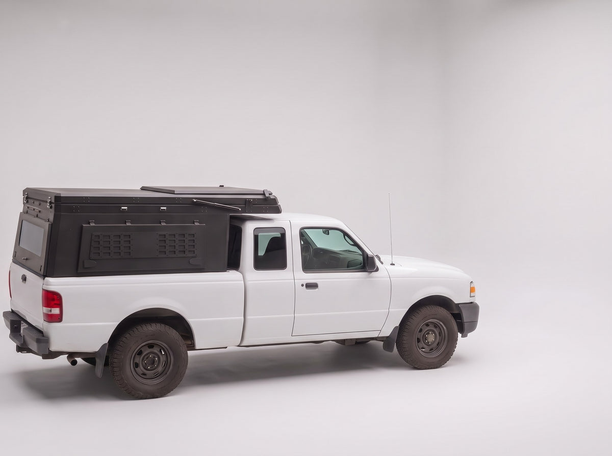 Step 1, closed for driving: the Double Pop-Up truck cap camper packed flat on a Ford Ranger