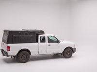 Step 1, closed for driving: the Double Pop-Up truck cap camper packed flat on a Ford Ranger