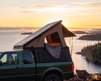 Ford Ranger pop-up truck cap camper with the roof tent open at sunset over Lake Superior