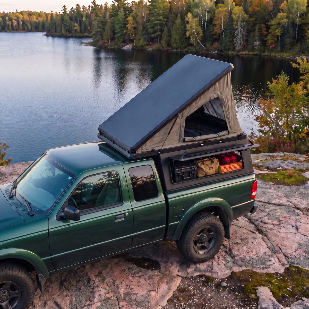 Ford Ranger Single Pop-Up truck cap camper with the roof tent open beside a northern Ontario lake