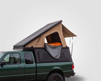 Studio side view of the Single Pop-Up truck cap camper on a Ford Ranger