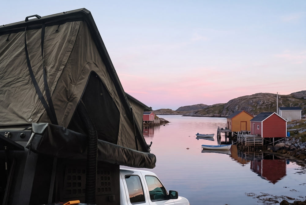 Side of the open roof tent on a Ford Ranger, overlooking a Newfoundland fishing cove at dawn (the side awning shown is not included)