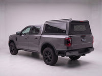 Ford Ranger truck cap with the honeycomb security guard showing through the tinted rear window, studio view
